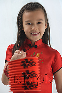 AsiaPix - Young girl in traditional Chinese dress holding red lantern and looking at camera