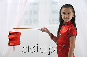 AsiaPix - Young girl in traditional Chinese dress holding red lantern and looking at camera