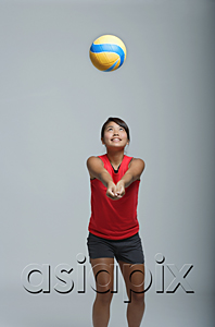 AsiaPix - Young woman playing with volleyball