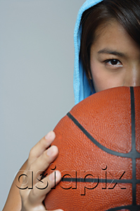 AsiaPix - Young woman with basketball looking at camera