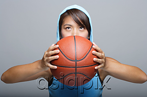 AsiaPix - Young woman with basketball looking up