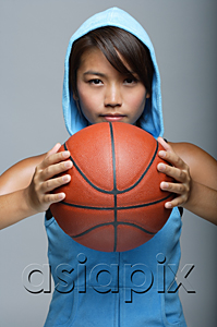 AsiaPix - Young woman with basketball looking at camera