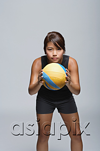 AsiaPix - Young woman with volleyball smiling at camera
