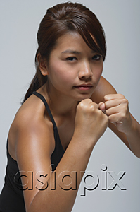 AsiaPix - Young woman with fists up looking at camera