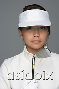 AsiaPix - Young woman in golfing outfit looking at camera