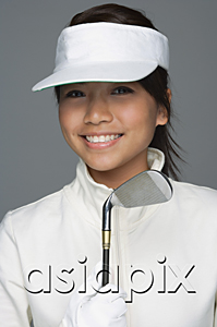 AsiaPix - Young woman in golfing outfit looking at camera