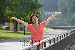 AsiaPix - Woman with arms outstretched looking into distance