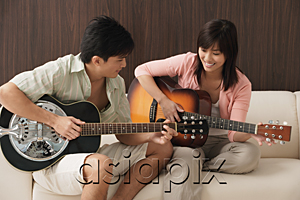AsiaPix - Young couple playing guitar
