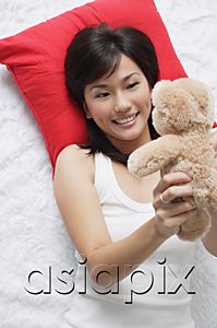 AsiaPix - Young woman playing with teddy