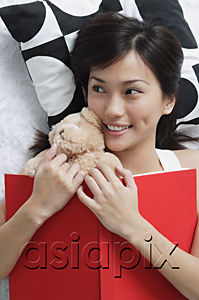 AsiaPix - Young woman with teddy and book