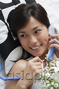 AsiaPix - Young woman smiling while on the phone