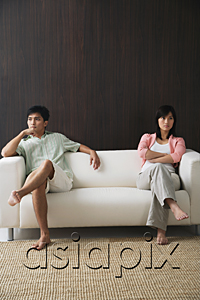 AsiaPix - Young couple sitting on opposite ends of the sofa