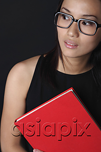 AsiaPix - Young woman with book looking into distance
