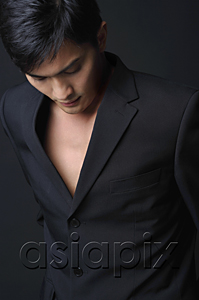 AsiaPix - Young man in black suit looking down