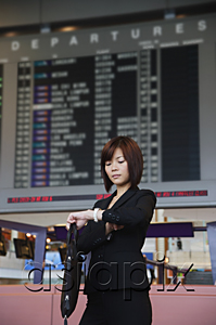 AsiaPix - Young woman waiting at the airport