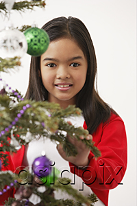 AsiaPix - Girl by the Christmas tree, looking at camera