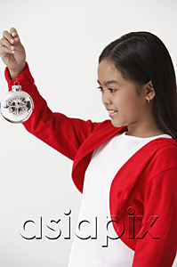 AsiaPix - Girl holding up Christmas decoration