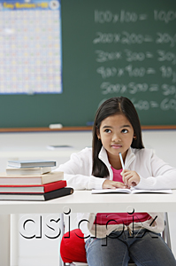AsiaPix - Girl sitting at school desk in classroom