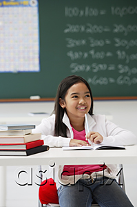 AsiaPix - Girl smiling sitting at school desk