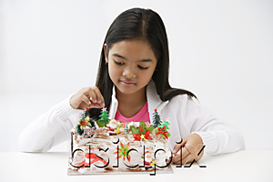 AsiaPix - Girl looking at Christmas log cake