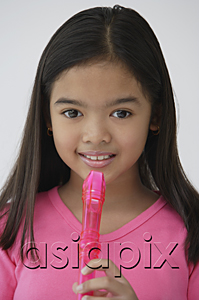 AsiaPix - Girl with pink recorder, looking at camera