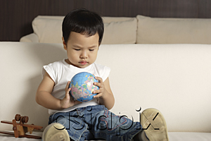 AsiaPix - Baby boy playing with globe