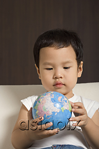 AsiaPix - Baby boy looking at globe