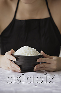 AsiaPix - Young woman holding bowl of rice with both hands