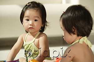 AsiaPix - Baby girls sitting and one looking at camera