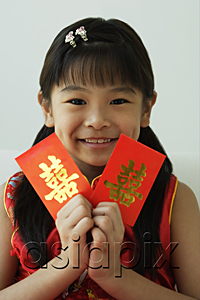 AsiaPix - Girl with double happiness red packet, smiling at camera