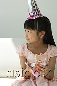 AsiaPix - Birthday girl with cupcake looking sideways
