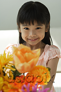 AsiaPix - Girl with flowers smiling at camera