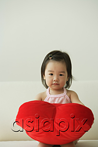 AsiaPix - Baby girl with heart-shaped cushion