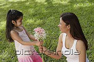PictureIndia - A young girl gives her mother a bunch of flowers