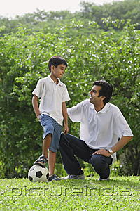 PictureIndia - A father and son play soccer together