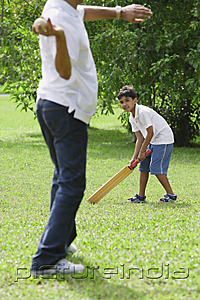 PictureIndia - A father and son play cricket together