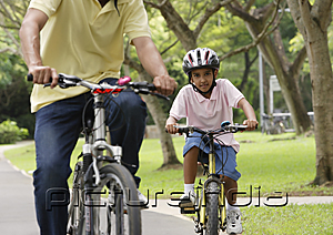 PictureIndia - A father and son ride their bikes together