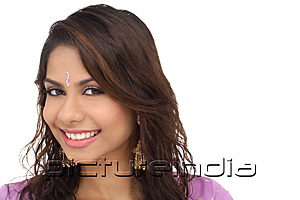 PictureIndia - A young woman with a bindi smiles at the camera