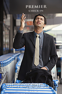 PictureIndia - Man gesturing and looking up