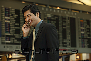 PictureIndia - Man talking on the phone at airport