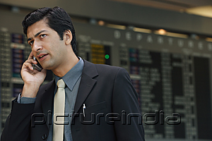 PictureIndia - Man talking on phone at airport