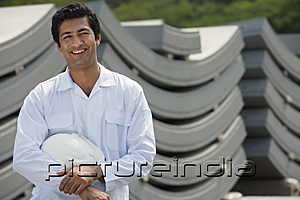 PictureIndia - Man in work uniform, smiling at camera