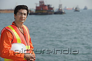 PictureIndia - Man in work uniform working at port