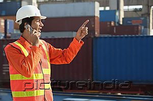 PictureIndia - Man in work uniform talking on mobile phone