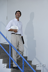 PictureIndia - Man smiling while walking down stairs