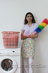 PictureIndia - Woman with feather duster, looking at camera