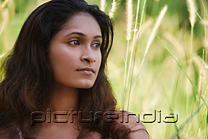 PictureIndia - Young woman looking into distance