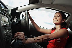 PictureIndia - Young woman driving car