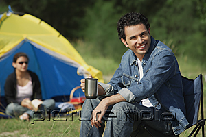 PictureIndia - Young man camping with girlfriend