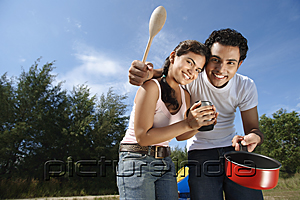 PictureIndia - Young couple camping and cooking in the wilderness